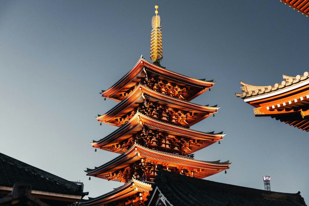 A tall, ornate pagoda against a clear blue sky.